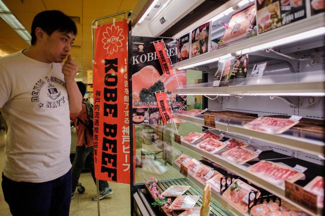  A customer looks at a display highlighting the sale of newly imported 