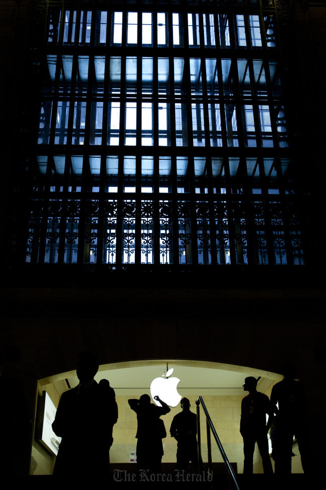 Apple Inc. employees walk through the new Apple retail location in Grand Central Terminal in New York. (Bloomberg)