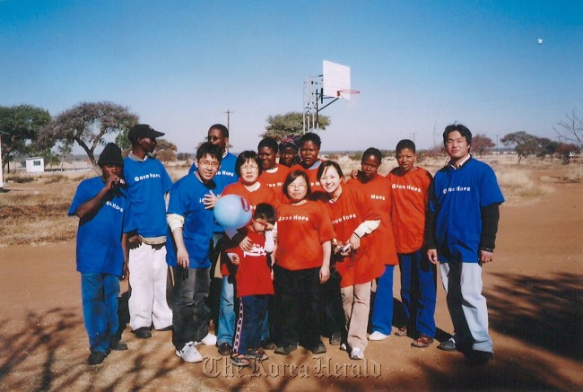 Kim Hai-yung poses with friends and students at the Stump Vocational Training Institue in Good Hope, Botswana, in 2011.