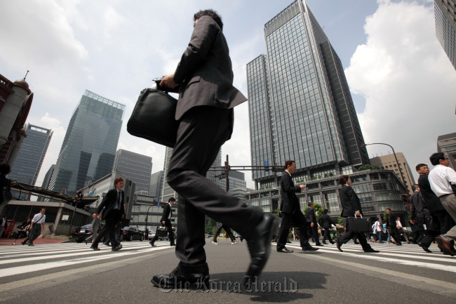 Morning commuters make their way to work in Tokyo. (Bloomberg)