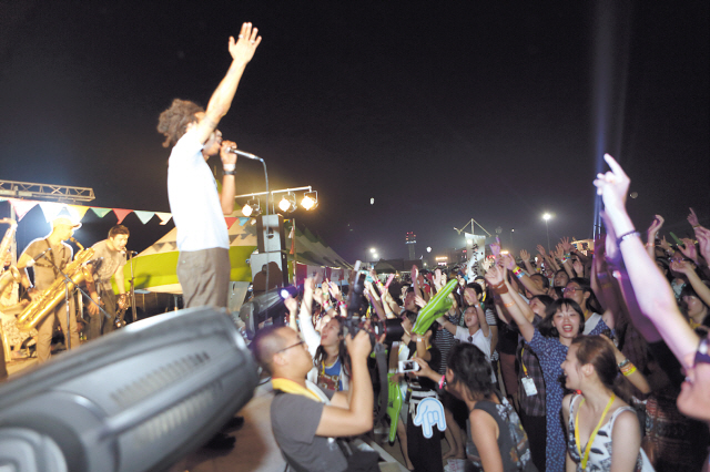 Snow Patrol vocalist Gary Lightbody sings to the crowd at Pentaport Rock Festival in Incheon on Saturday (top). T-Bone Ska from Thailand entertains the crowd at the Rockers Stage after-hours at Pentaport Rock Festival. (Dennis KH Kim)