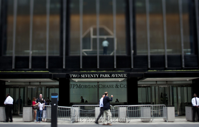 Pedestrians pass in front of the JPMorgan Chase & Co. headquarters in New York. (Bloomberg)