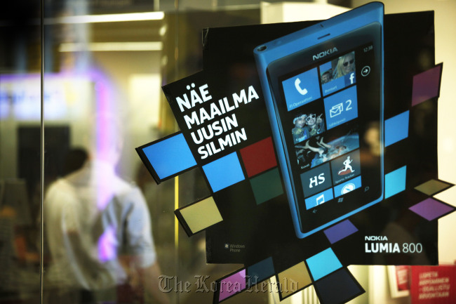 An advertisement for the Nokia Lumia 800 is displayed at a mobile phone store in Helsinki, Finland. (Bloomberg)