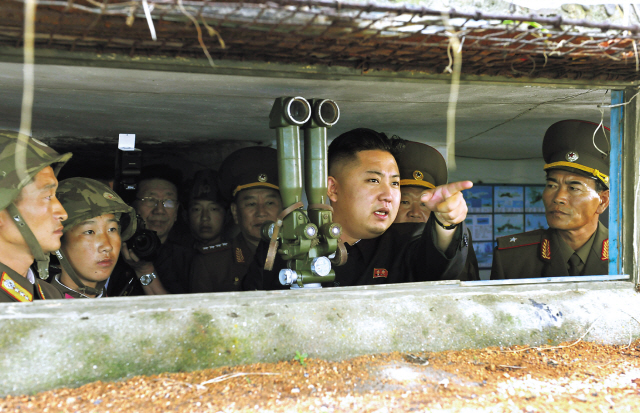 North Korean leader Kim Jong-un gestures as he inspects the island defense detachments stationed in the southernmost part of the southwest front Saturday. The unit was responsible for the artillery attack on South Korea’s Yeonpyeong Island on Nov. 23, 2010. (Xinhua-Yonhap News)