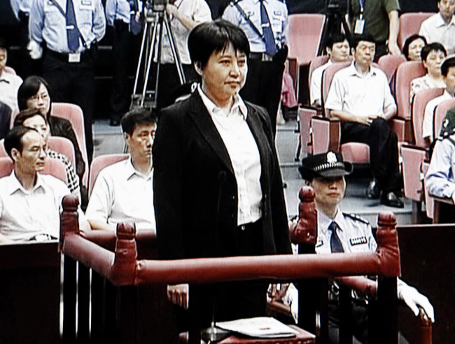 In this Aug. 9 file video image taken from CCTV, Gu Kailai (center), the wife of disgraced politician Bo Xilai, stands during her trial in the Hefei Intermediate People’s Court in Hefei in eastern China’s Anhui province. (AP-Yonhap News)