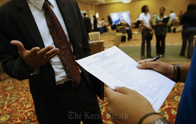 A recruiter reviews a job seeker’s resume during a Coast to Coast Career Fairs event in Houston, Texas. (Bloomberg)