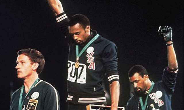 Peter Norman (left) stands with Tommie Smith and John Carlos on the podium in Mexico. (AP)