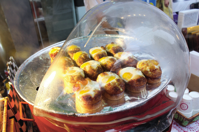 Steamed bread and egg are prepared on the spot on a Meyong-dong street on Aug. 18.