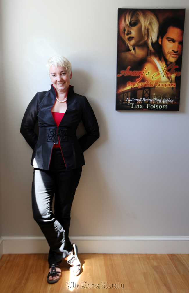 Self-published writer Tina Folsom is photographed in her home where many of her novel covers hang on her walls in San Francisco, California, on Aug. 6. (Contra Costa Times/MCT)