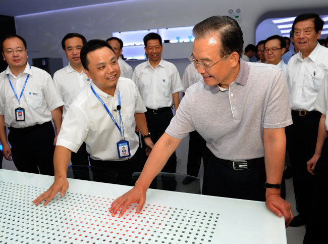 Chinese Premier Wen Jiabao (right) inspects an LED production company in Guangzhou city of south China’s Guangdong province on Friday. (Xinhua-Yonhap News)