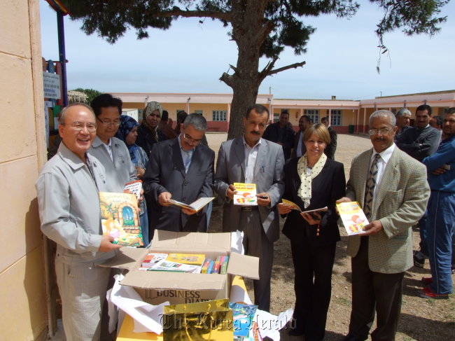 Officials from Daewoo Engineering and Construction pose with local community officials after donating books to a school in Hassasna, Algeria. (Daewoo E&C)