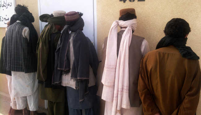 Six Taliban fighters stand handcuffed after they were captured with their ammunition by Afghan security forces in Helmand province, south of Kabul, Afghanistan, on Aug. 28, 2012. Afghan security forces captured six Taliban fighters with their ammunition during their operations on Tuesday, officials said. (Xinhua-Yonhap News)