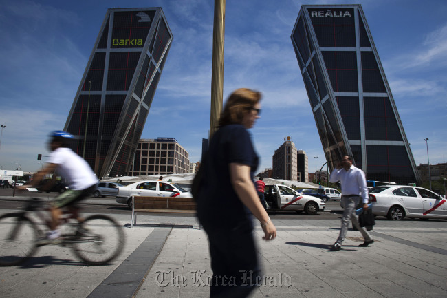 Pedestrians pass the Kio towers, the headquarters of Bankia SA in Madrid. (Bloomberg)