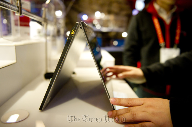 A Lenovo Group Ltd. Ideapad Yoga, a touchscreen clamshell computer which flips completely over on itself and can be used like a tablet, sits on display during the 2012 International Consumer Electronics Show in Las Vegas. (Bloomberg)