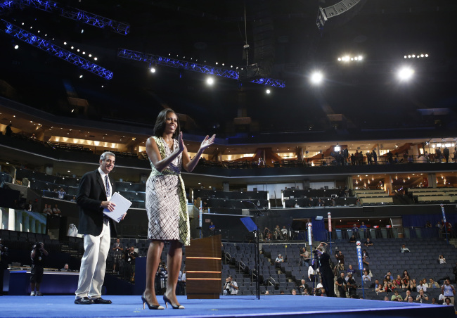 First Lady Michelle Obama gestures as she appears at the podium for a camera test on the stage at the Democratic National Convention inside Time Warner Cable Arena in Charlotte, North Carolina on Monday. (AP-Yonhap News)