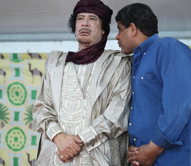 In this Oct. 6, 2009 file photo, intelligence chief Abdullah al-Senoussi (right) whispers to Libyan leader Moammar Gadhafi in Sabha, Libya. (AP-Yonhap News)