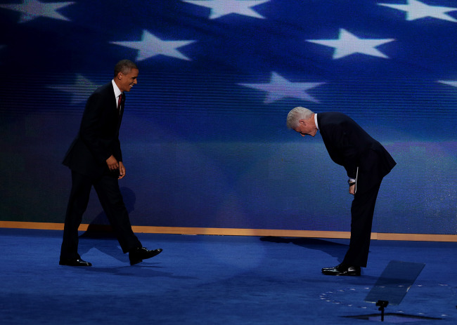 U.S President Barack Obama (left) smiles while arriving on stage as former U.S. President Bill Clinton bows during day two of the Democratic National Convention in Charlotte, North Carolina, Wednesday. (Bloomberg)