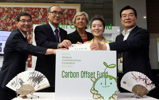 Participants of the 2012 IUCN World Conservation Congress pose for photos after making donations to a carbon offseting program designed to reduce carbon dioxide produced during their travel to the conference. From left: Yoon Seung-joon, president of Korea Environmental Technology & Industry Institute; Lee Hong-koo, chairman of the Korean Organizing Committee of the 2012 WCC; Julia Marton-Lefevre, IUCN secretary-general; Yoo Young-sook, environmental minister of Korea; and Woo Keun-min, governor of Jeju Self-Governing Province. (Yonhap News)