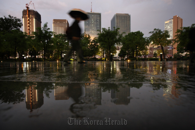 A pedestrian walks past commercial buildings in Osaka. (Bloomberg)