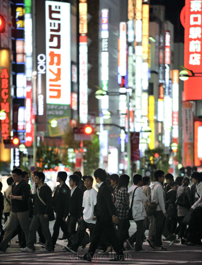 Pedestrians cross an intersection in the Shinjuku district of Tokyo. (Bloomberg)