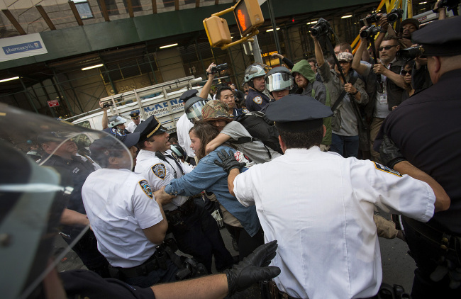 Officers with the New York City Police Department arrest protesters during an Occupy Wall Street demonstration in New York on Monday. (Bloomberg)