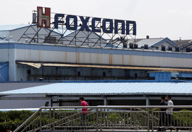 Workers walk outside a Foxconn plant in Shenzhen, Guangdong province, China. (Bloomberg)