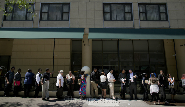 Job seekers wait in line to enter a Choice Career Fair in New York. (Bloomberg)