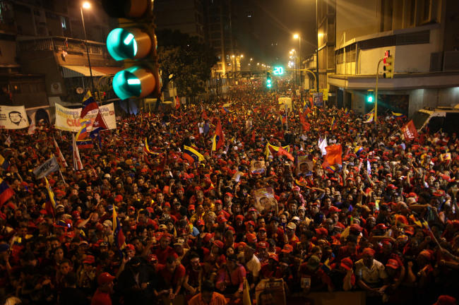 Supporters of President Hugo Chavez gather next to the Miraflores presidential palace as they celebrate in Caracas, Venezuela, Sunday. (AP-Yonhap News)