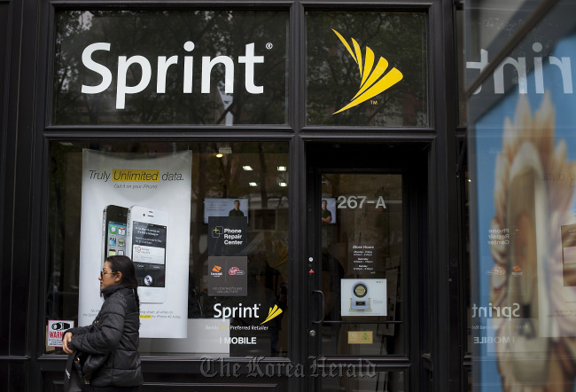 A pedestrian passes in front a Sprint Nextel Corp. store in New York. (Bloomberg)