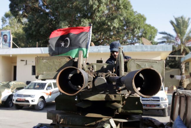 A Libyan soldier sits on an armed vehicle flying the national flag in the coastal city of Benghazi on Sunday. ( AFP-Yonhap News)