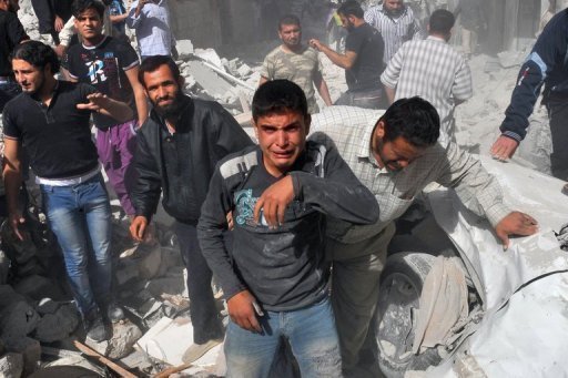 Syrian men are seen following an airstrike by the government forces in Maaret al-Numaan. (AFP)