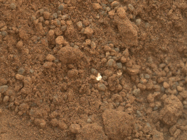 This handout photo provided by NASA/JPL-Caltech/MSSS, taken Oct. 15, 2012, shows part of the small pit or bite created when NASA`s Mars rover Curiosity collected its second scoop of Martian soil at a sandy patch called 