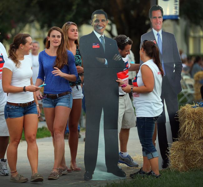 People look at cardboard cutouts of U.S. President Barack Obama and Republican presidential candidate Mitt Romney at Lynn University as the campus prepares for the final presidential debate in Boca Raton, Florida, Saturday. (AFP-Yonhap News)