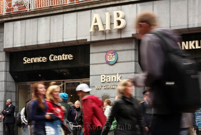 Pedestrians pass a branch of the Allied Irish Bank in Grafton Street, Dublin. (Bloomberg)