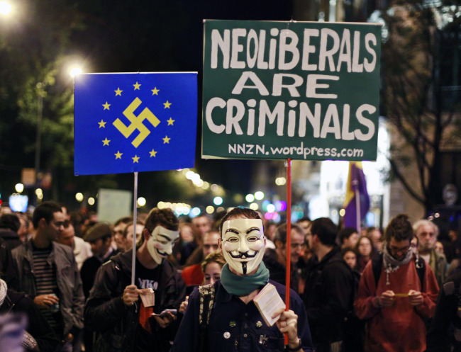 Protesters demonstrate outside the parliament in Madrid on Tuesday. (AP-Yonhap News)