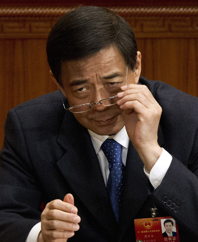 Former Chongqing party secretary Bo Xilai adjusts his glasses during a plenary session of the National People's Congress at the Great Hall of the People in Beijing in March.(AP-Yonhap News)