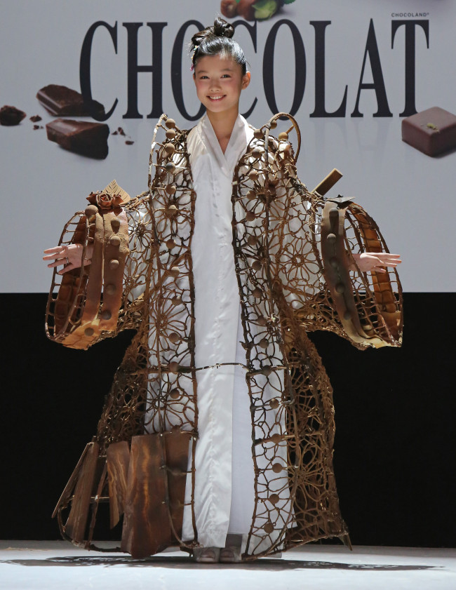 Kim Yoo Jung wears a creation made with chocolate during a fashion show at the inauguration of the 18th annual Salon du Chocolat in Paris on October 30, 2012. The show, the world's biggest dedicated to chocolate, brings together fashion designers and chocolatiers from around the world. (UPI)