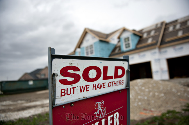 A “Sold” sign stands outside a new home in Peoria, Illinois. (Bloomberg)