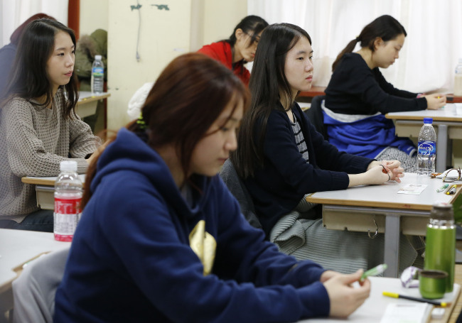 South Korean students prepare to take the College Scholastic Ability Test, a standardised exam for college entrance, at a school in Seoul on Thursday. (Yonhap News)