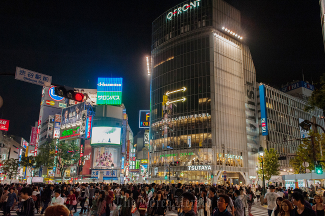 People cross an intersection at night in the Shibuya district of Tokyo. (Bloomberg)