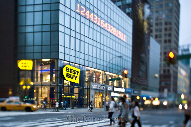 Pedestrians pass in front of a Best Buy Co. store in New York. (Bloomberg)