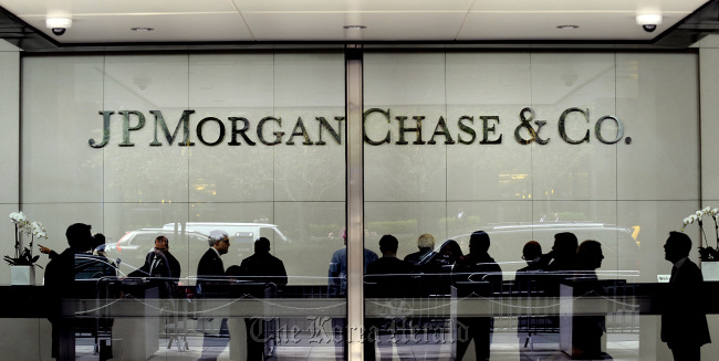 People stand inside of JPMorgan & Chase Co. headquarters in New York. ( Bloomberg)