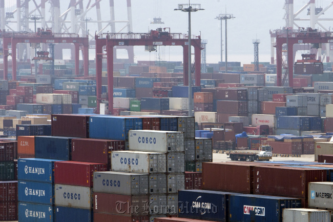 Containers are stacked at a shipping terminal in Tokyo. (Bloomberg)