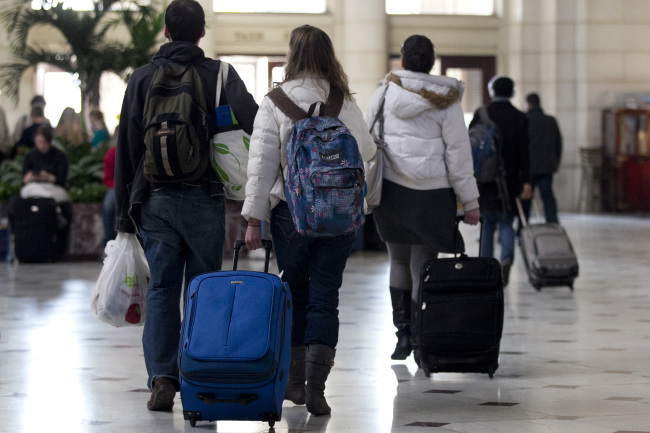 Travelers pull luggage while walking out of Union Station in Washington, D.C., Wednesday. (Bloomberg)