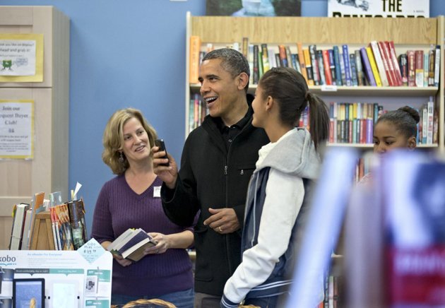 President Barack Obama, with daughters Sasha, far right, and Malia, center, goes shopping at a small bookstore, One More Page, in Arlington, Va., Saturday, Nov. 24, 2012. (AP)