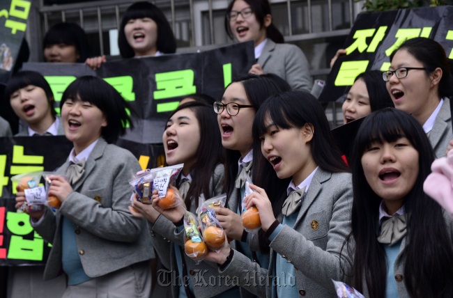 Students cheer those who take the national college entry exam on Nov. 8 in Seoul. (Park Hae-mook/The Korea Herald)