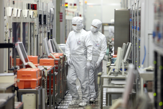 Employees work at Renesas Electronics Corp.’s Naka plant in Hitachinaka city, Japan. (Bloomberg)