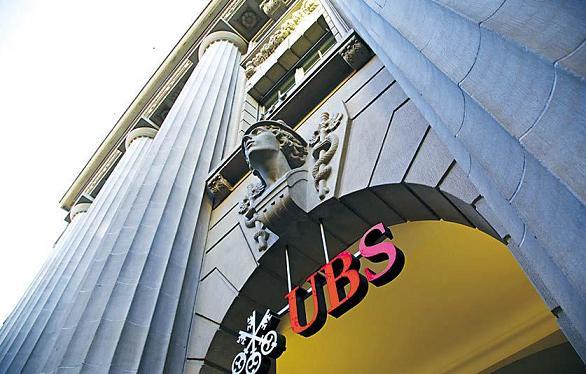 A UBS AG sign hangs above the entrance to the company’s headquarters in Zurich. (Bloomberg)