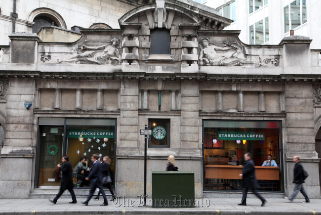 Pedestrians pass a Starbucks in London. (Bloomberg)