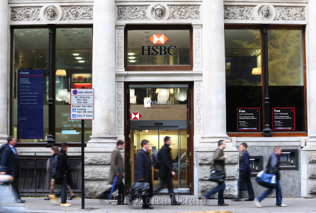 Pedestrians pass a HSBC Holdings Plc bank branch in London. (Bloomberg)